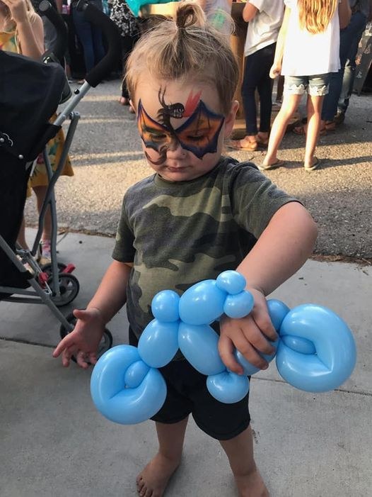 Balloon Motorcycle Creation Child holding a blue balloon motorcycle creation