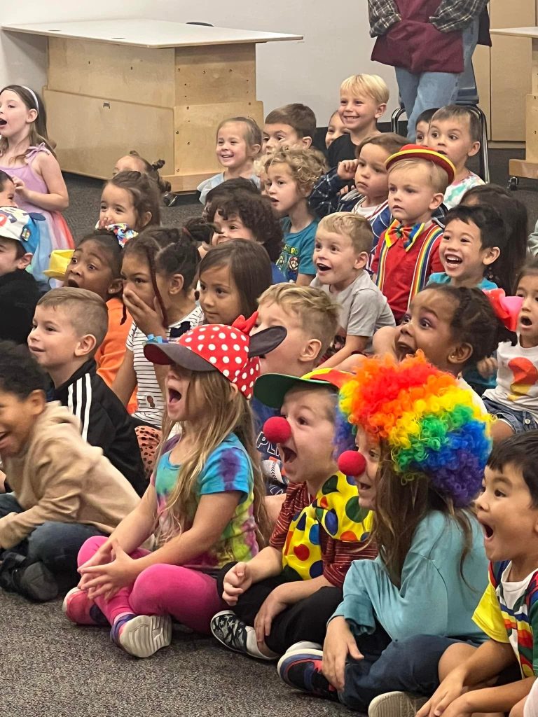 Children laughing and reacting during a lively Sparkles performance