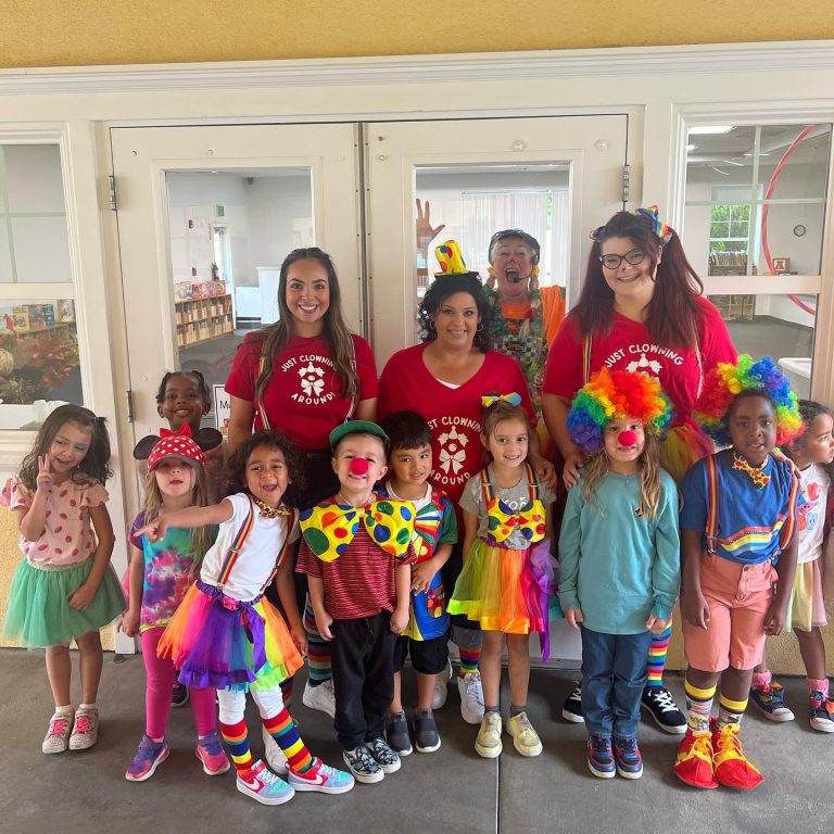 Sparkles' entertainment team posing with children after a colorful event