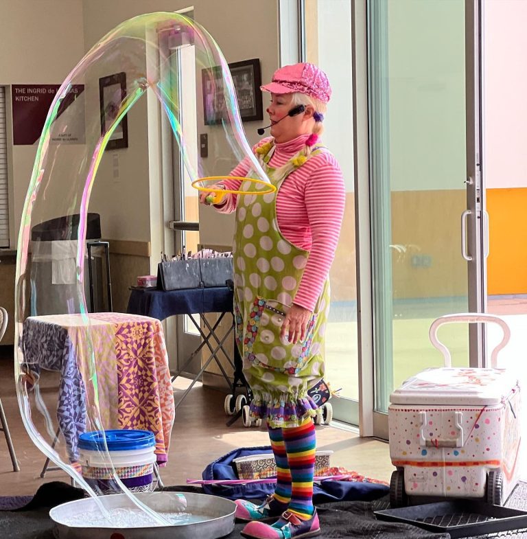 Sparkles demonstrating a giant bubble activity with colorful bubble equipment
