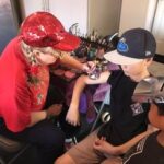 Glitter body art being applied to a guest at an event